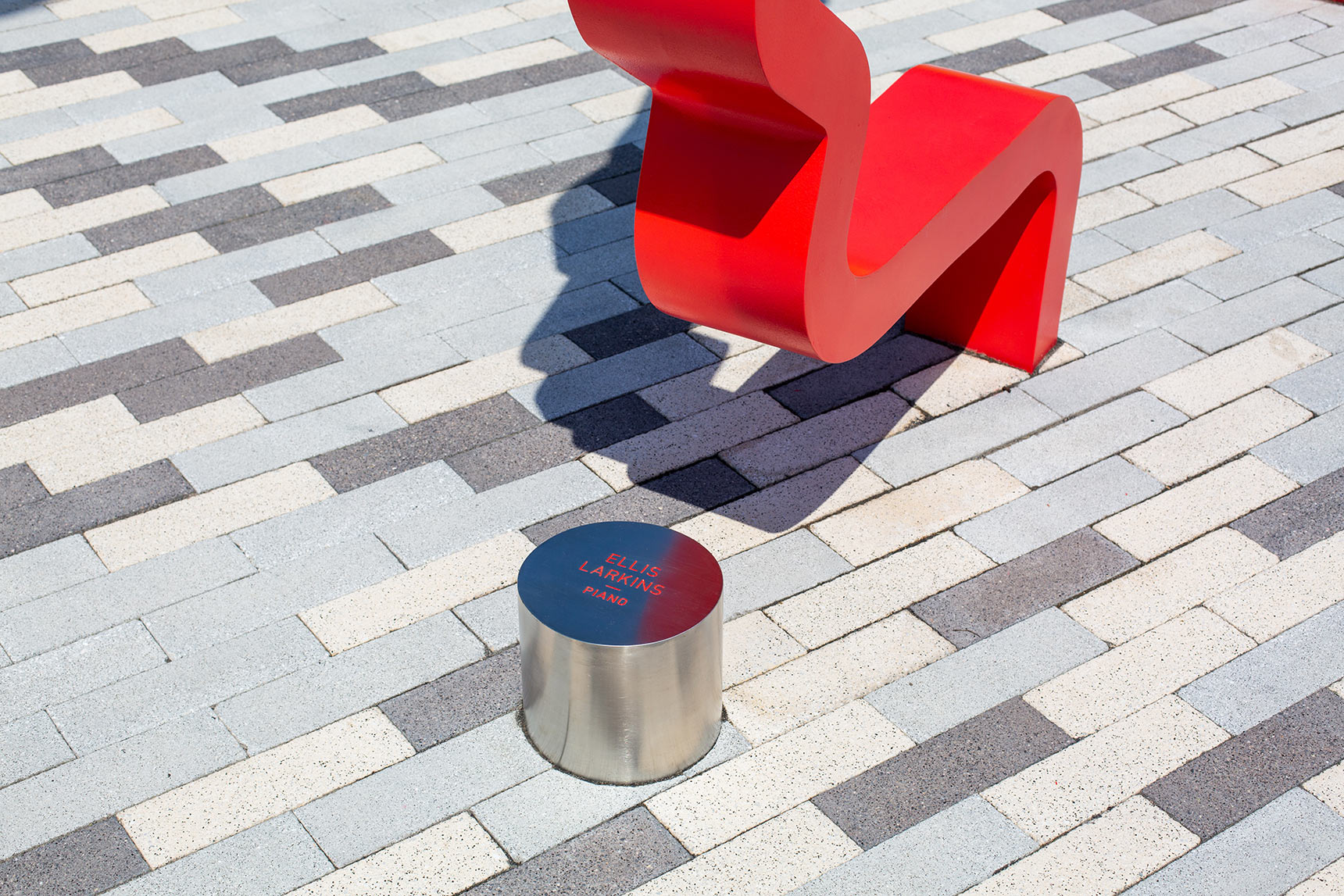 Detail photo showing stainless steel bollard engraved with the name of jazz musician Ellis Larkins, at the Harmonic Time sculpture