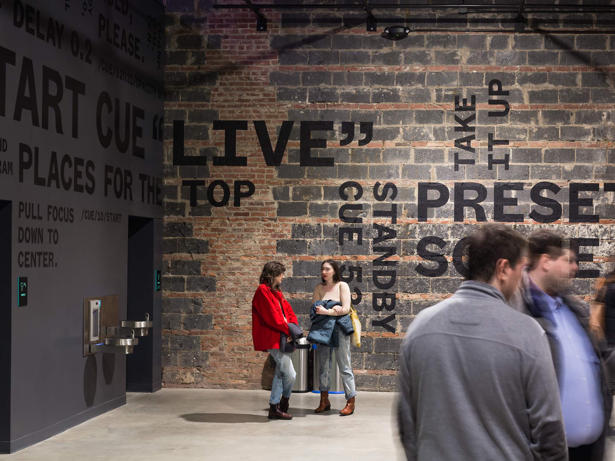 Typographic mural lettering and kinetic poetry wrap around the lobby of The Voxel Theater