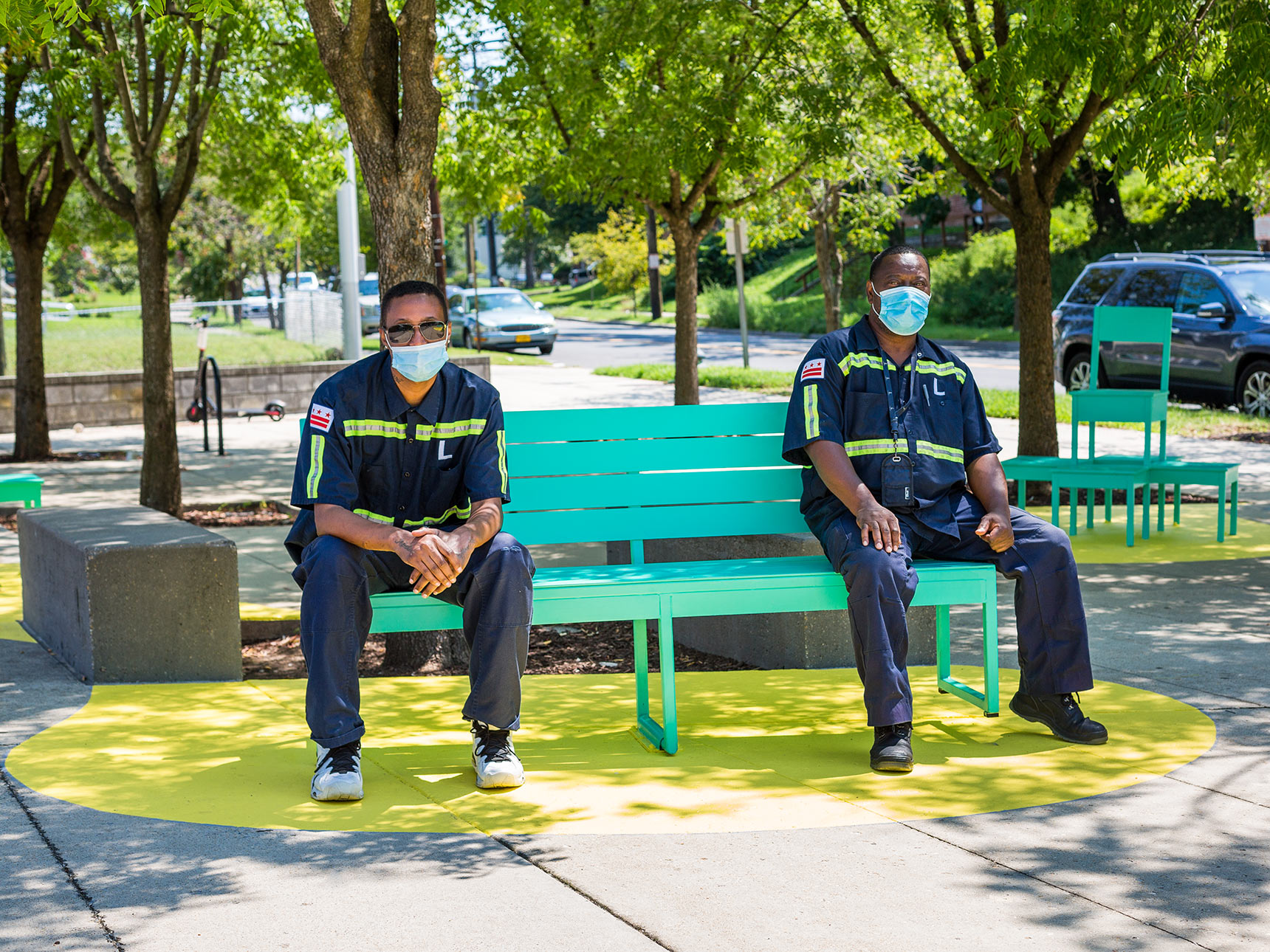 Two men on Seesaw Bench, part of The Chairs, a sculptural seating public art installation in Washington DC.