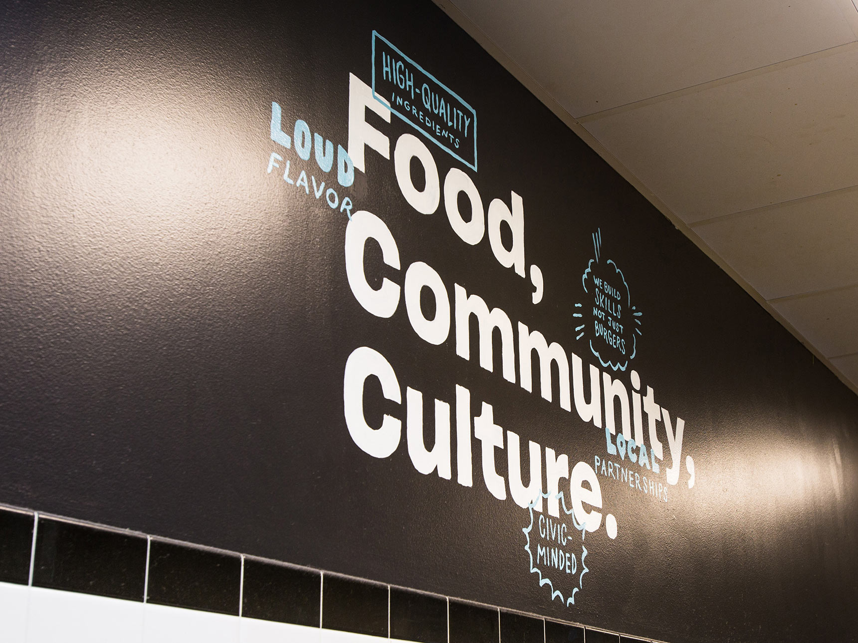 Food, Community, Culture. mural at Noisy Burger food stall