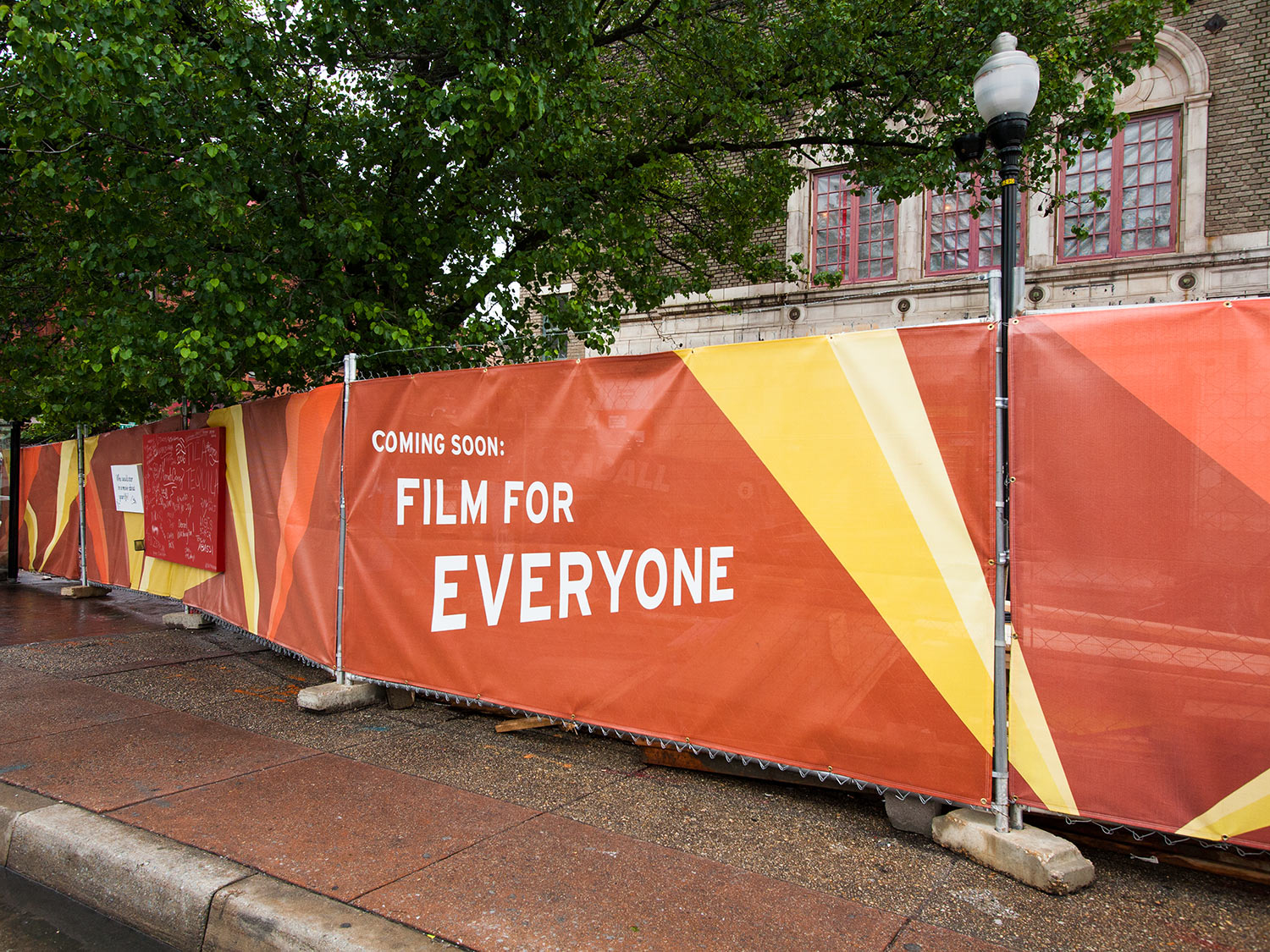 Interactive chalkboard construction fencing surrounding the Parkway Theatre in Baltimore during its renovation by the Maryland Film Festival