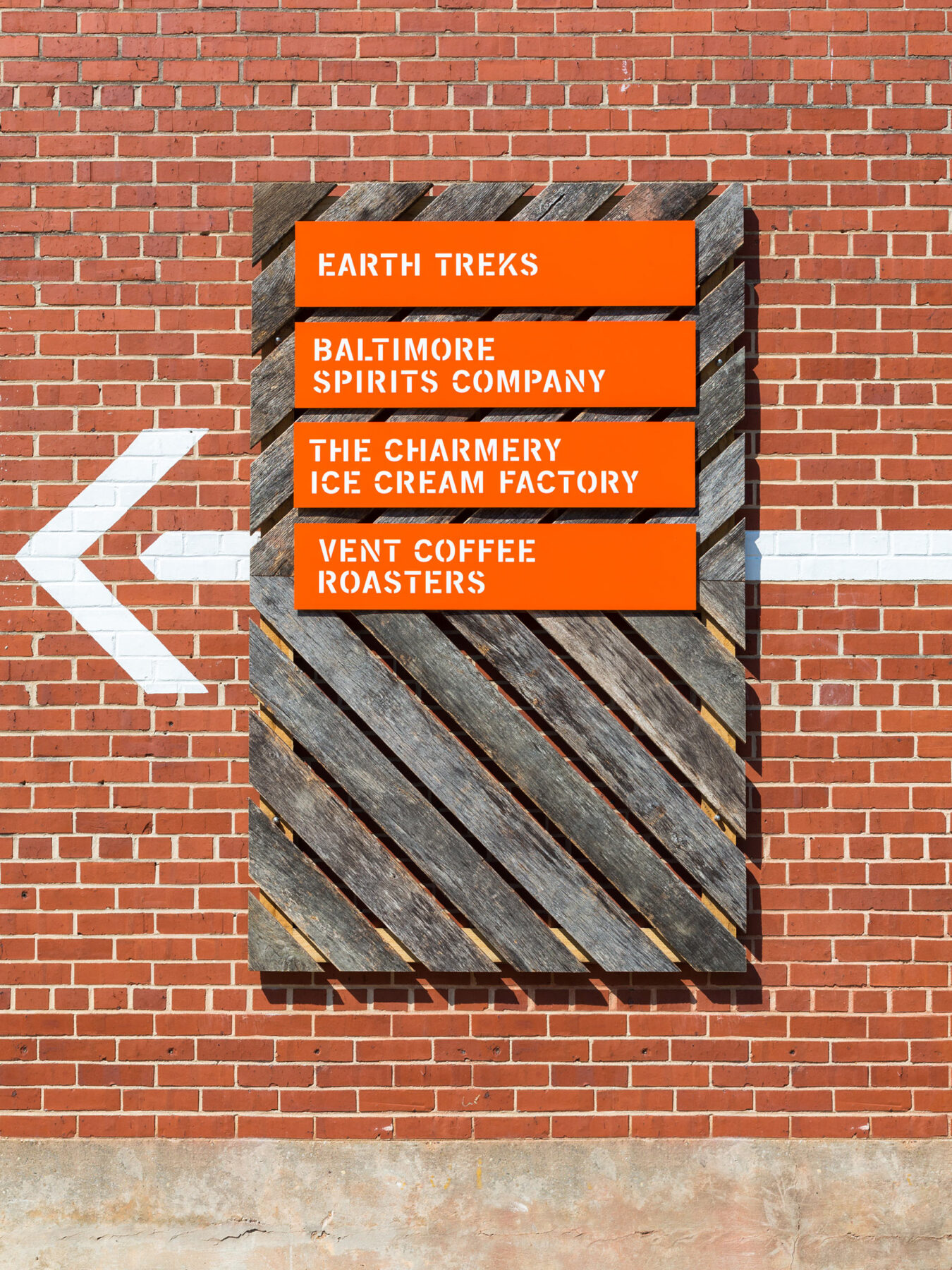 Custom wayfinding signage with stencil lettering on the Union Collective warehouse building
