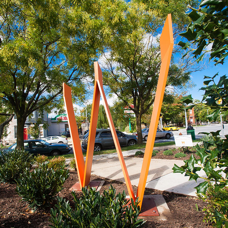 Waverly W large sculptural orange alphabet letter W, neighborhood gateway signage in Baltimore's Waverly neighborhood