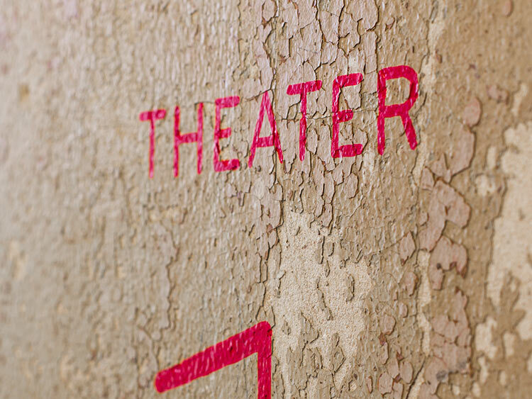 Hand-painted wayfinding signage and graphics in the lobby of the historic MdFF SNF Parkway Theatre, a contemporary film and arts center in Baltimore